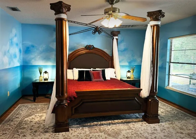 a bedroom with a bed and a window