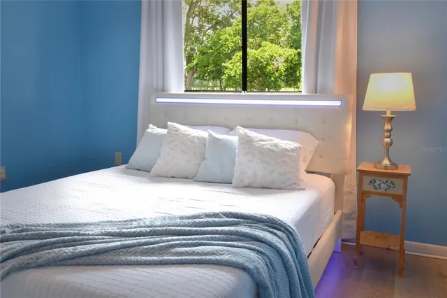 a bedroom with a bed and a window