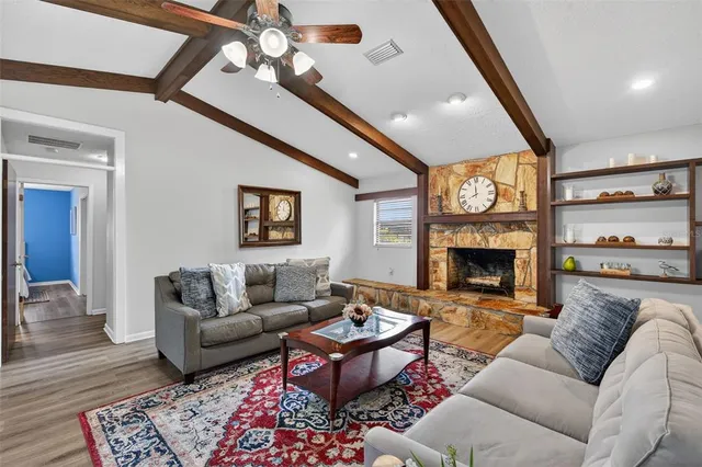 a kitchen with stainless steel appliances granite countertop a refrigerator a stove and a sink