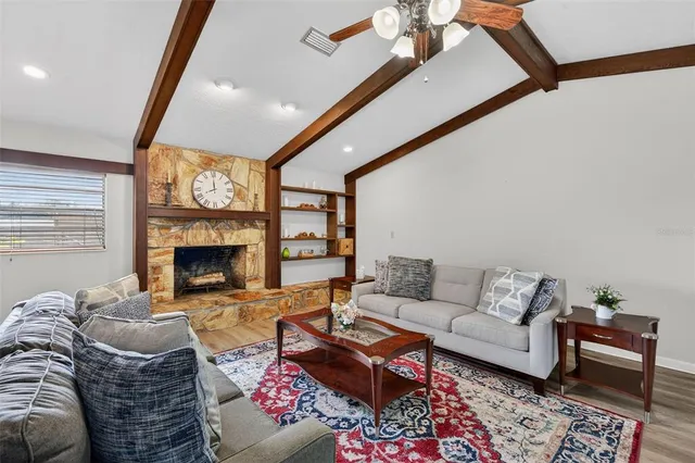 a kitchen with granite countertop a refrigerator and a stove top oven