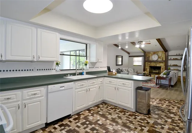 a kitchen with granite countertop a sink and cabinets