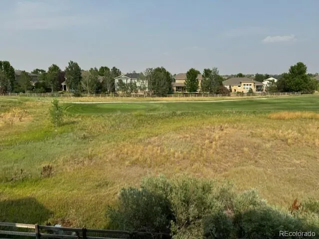 a view of a green field with clear sky