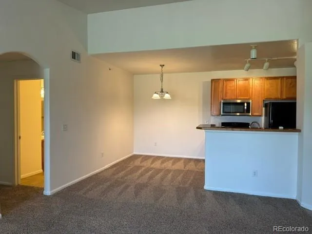 a kitchen with a refrigerator and a stove