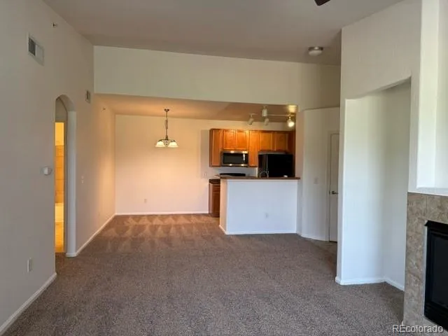 a view of a room with a kitchen