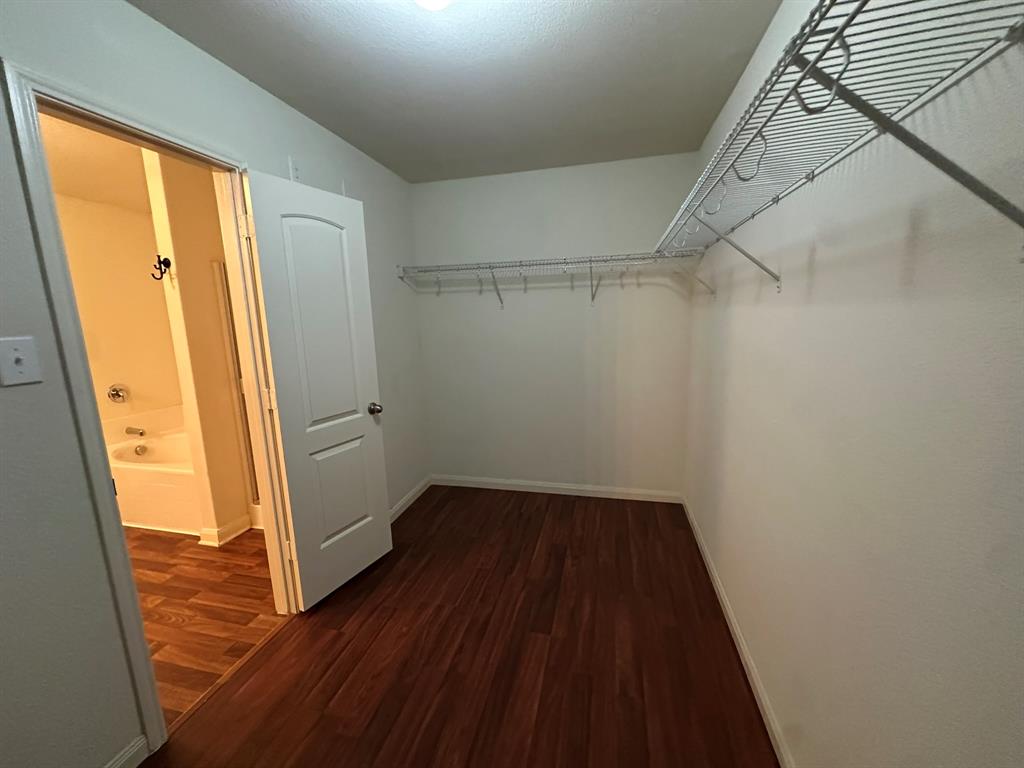 1818 Clegg Street Howe, TX 75459 - Photo 19 of 34 Spacious closet featuring wood-finish flooring, white walls, and wire shelving