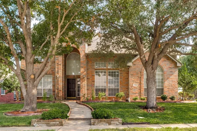 front view of a building with a tree