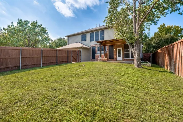 a view of a house with a yard and sitting area