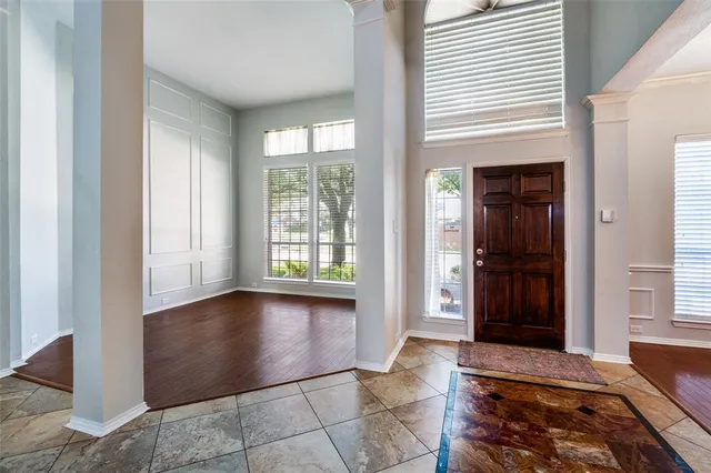 a view of a livingroom with wooden floor and a window
