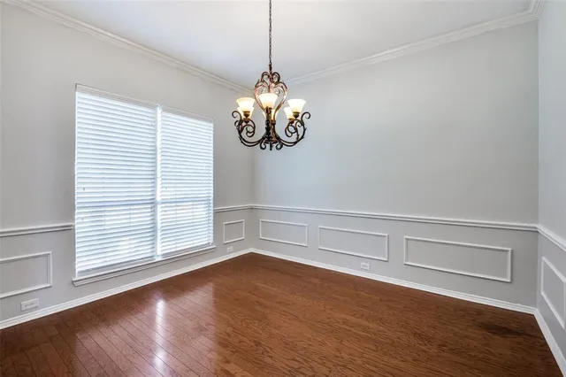 a view of a room with wooden floor and windows