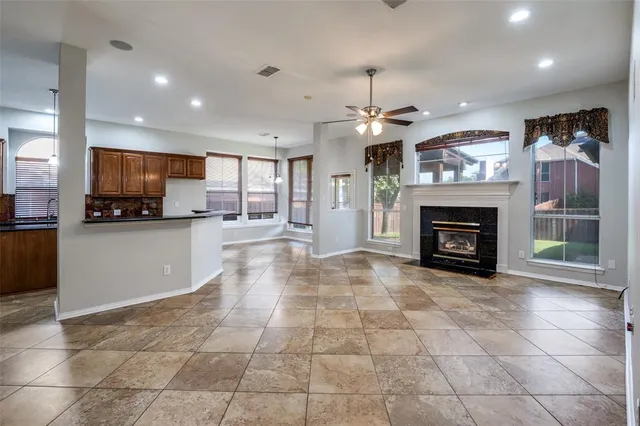 a large kitchen with cabinets and a fireplace