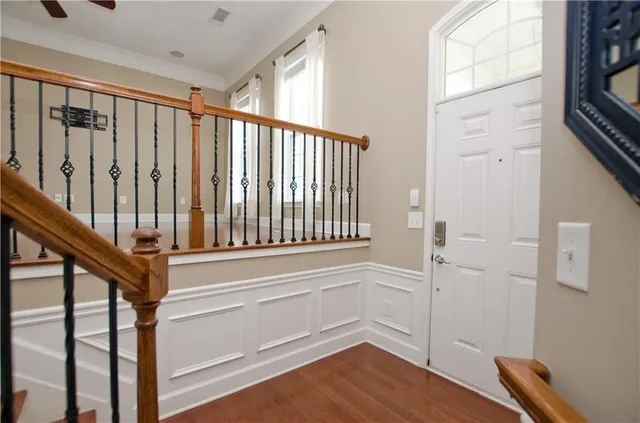 a view of entryway and hall with wooden floor