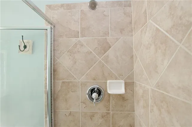 a bathroom with a sink mirror and a shower