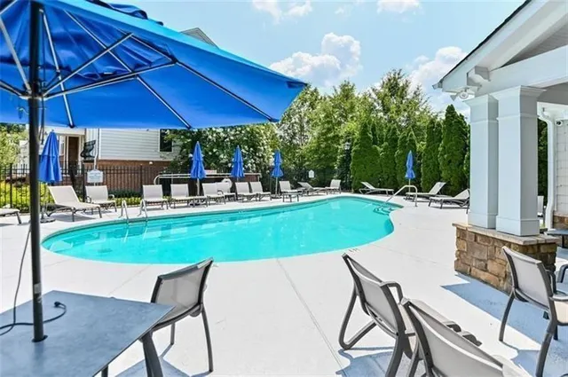 a swimming pool with outdoor seating yard and barbeque oven
