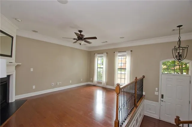 a view of staircase with lots of frames on wall and a window