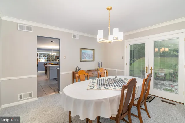 a view of a dining room with furniture wooden floor and chandelier