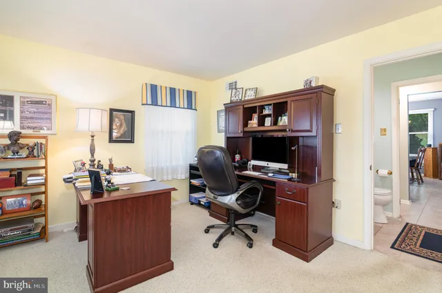 a view of a workspace with furniture and a bedroom