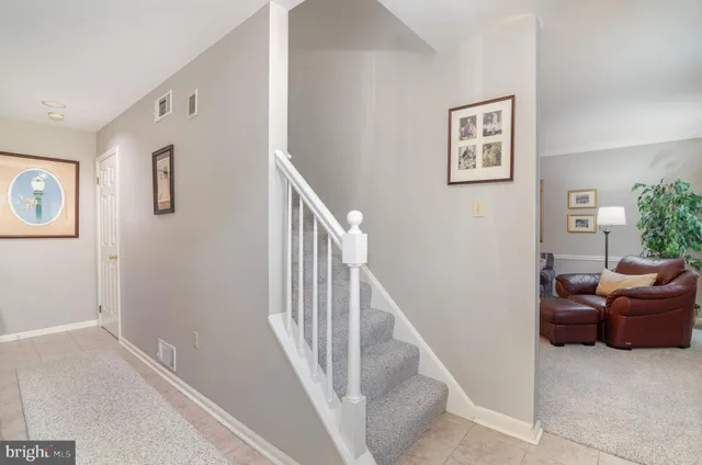 a view of a livingroom with furniture and staircase