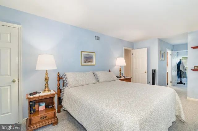 a bedroom with a bed and a lamp