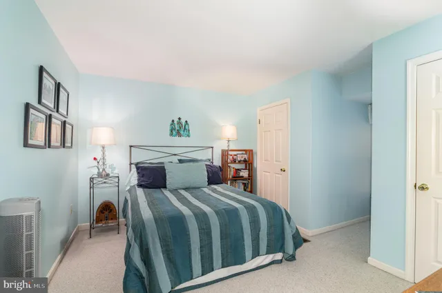 a bedroom with a large bed and a painting on the wall