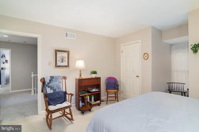 a bedroom with a bed and a chair in it