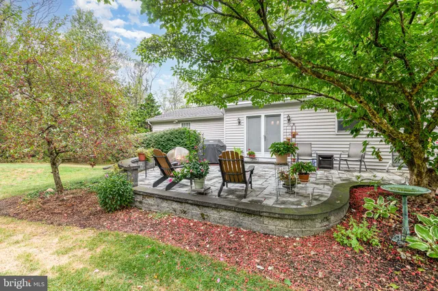 a view of a house with backyard and sitting area