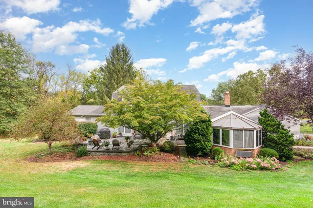 a view of a house with backyard and sitting area