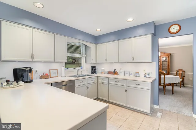 a kitchen with cabinets and window