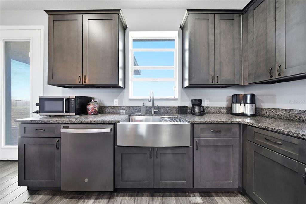 3090 80 Foot Road Bartow, FL 33830 - Photo 12 of 48 a kitchen with cabinets a sink and stainless steel appliances