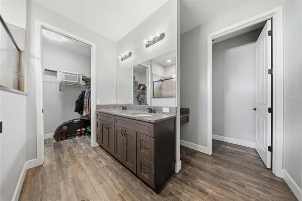 a kitchen with a sink cabinets and wooden floor