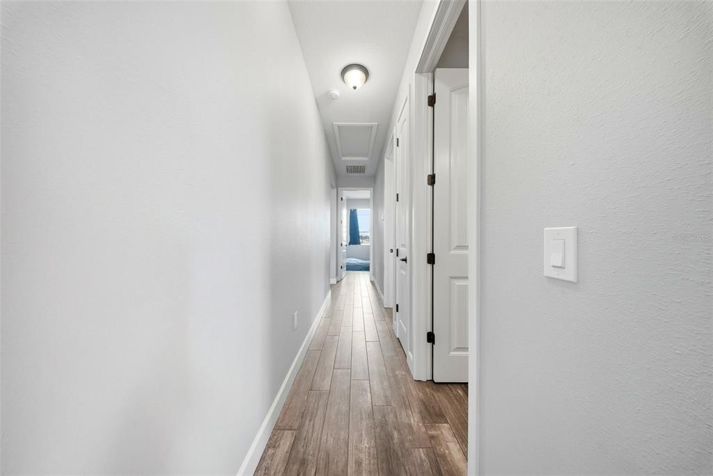3090 80 Foot Road Bartow, FL 33830 - Photo 22 of 48 a view of a hallway with wooden floor and a bathroom