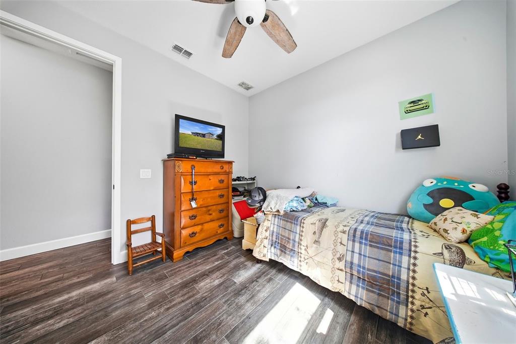 3090 80 Foot Road Bartow, FL 33830 - Photo 27 of 48 a bedroom with furniture and a wooden floor