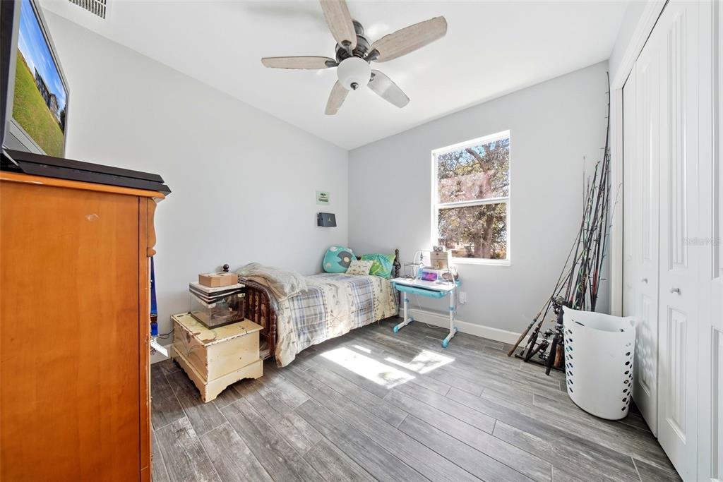 3090 80 Foot Road Bartow, FL 33830 - Photo 28 of 48 a bedroom with furniture and a wooden floor