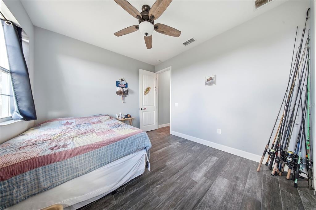 3090 80 Foot Road Bartow, FL 33830 - Photo 29 of 48 a bedroom with a bed and a chandelier