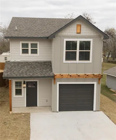 a front view of a house with a garage and yard