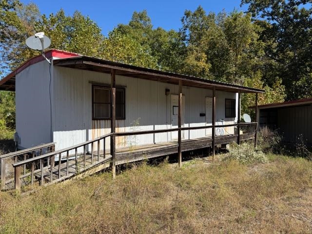 4280 Powell Chapel Road Middleton, TN 38052 - Photo 6 of 12 a view of backyard with large trees and wooden fence