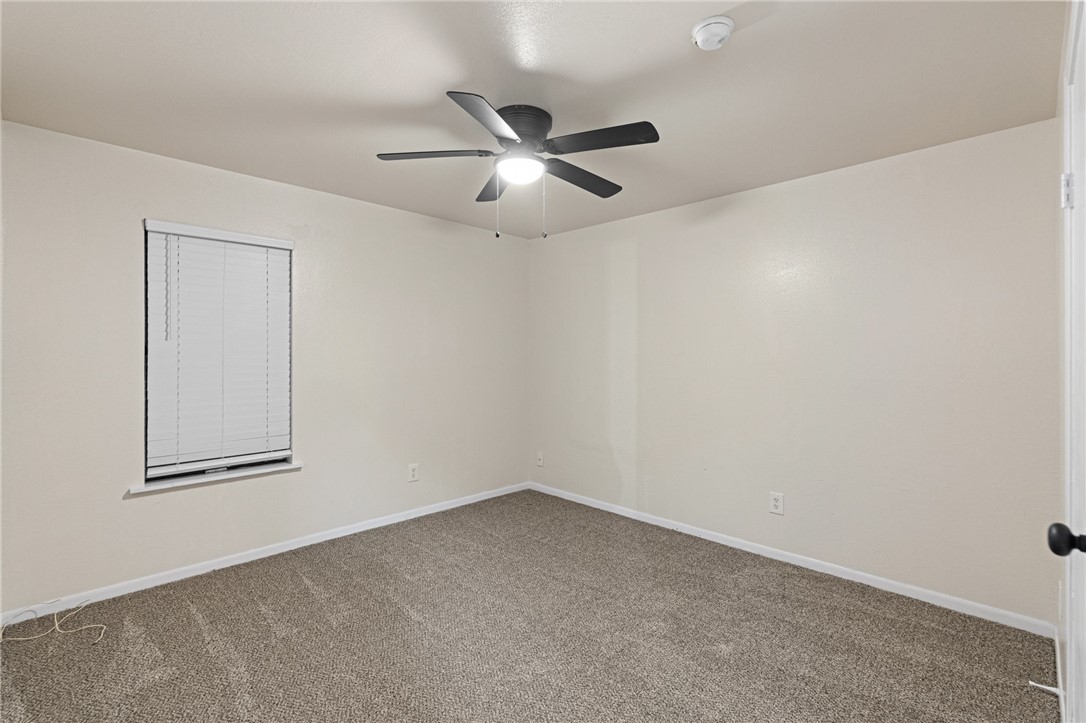 5921 Riley Drive Corpus Christi, TX 78412 - Photo 15 of 20 an empty room with a window and ceiling fan
