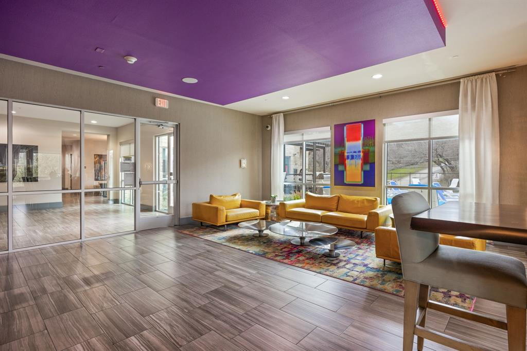 1900 Barton Springs Road, Unit 3013 Austin, TX 78704 - Photo 20 of 27 A vibrant common area features striking recessed lighting and durable tile flooring leading to a sun-filled outdoor space.