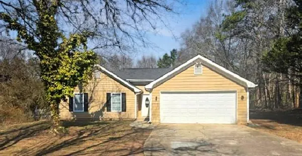 a view of a house with a yard and garage
