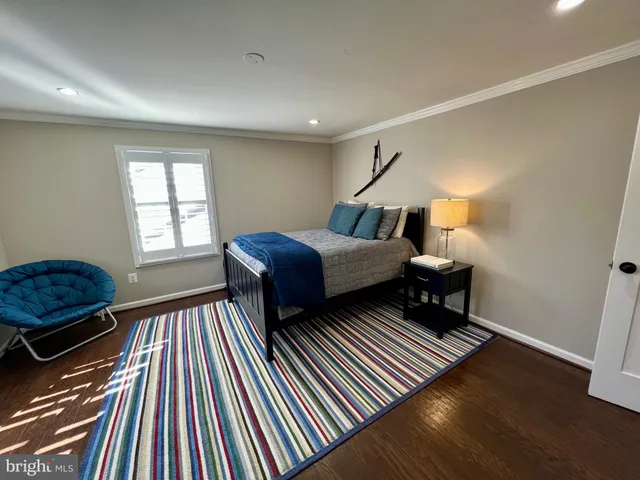 a bedroom with a bed and a large mirror