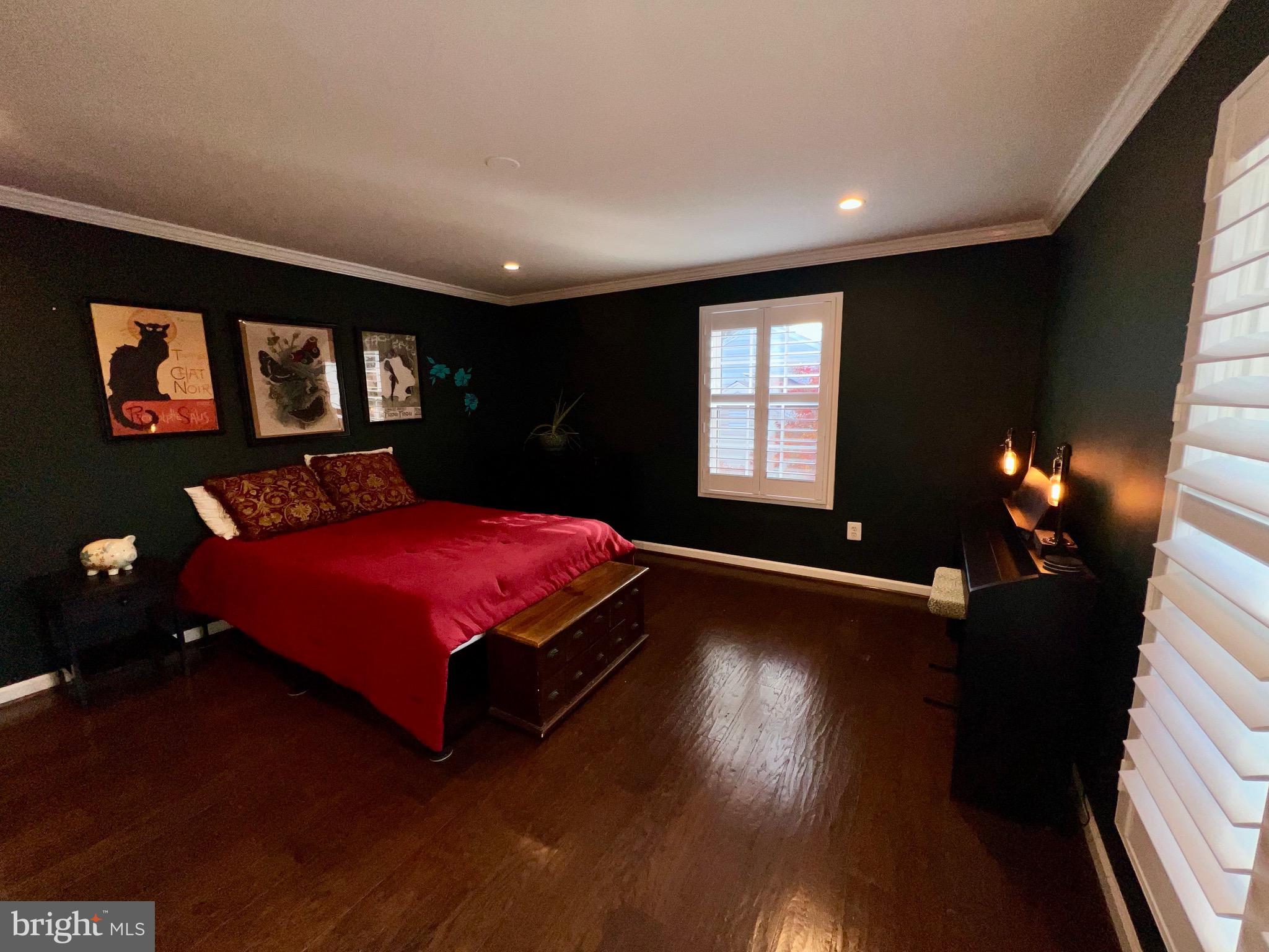 909 St Stephens Road Alexandria, VA 22304 - Photo 22 of 40 a bedroom with a bed and wooden floor