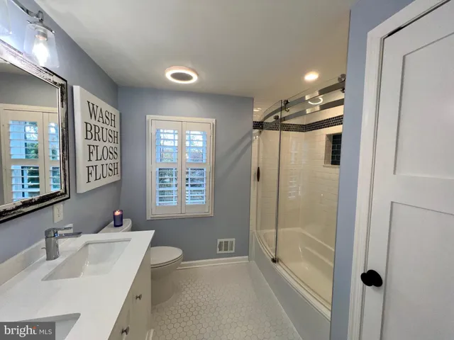 a kitchen with refrigerator cabinets and wooden floor