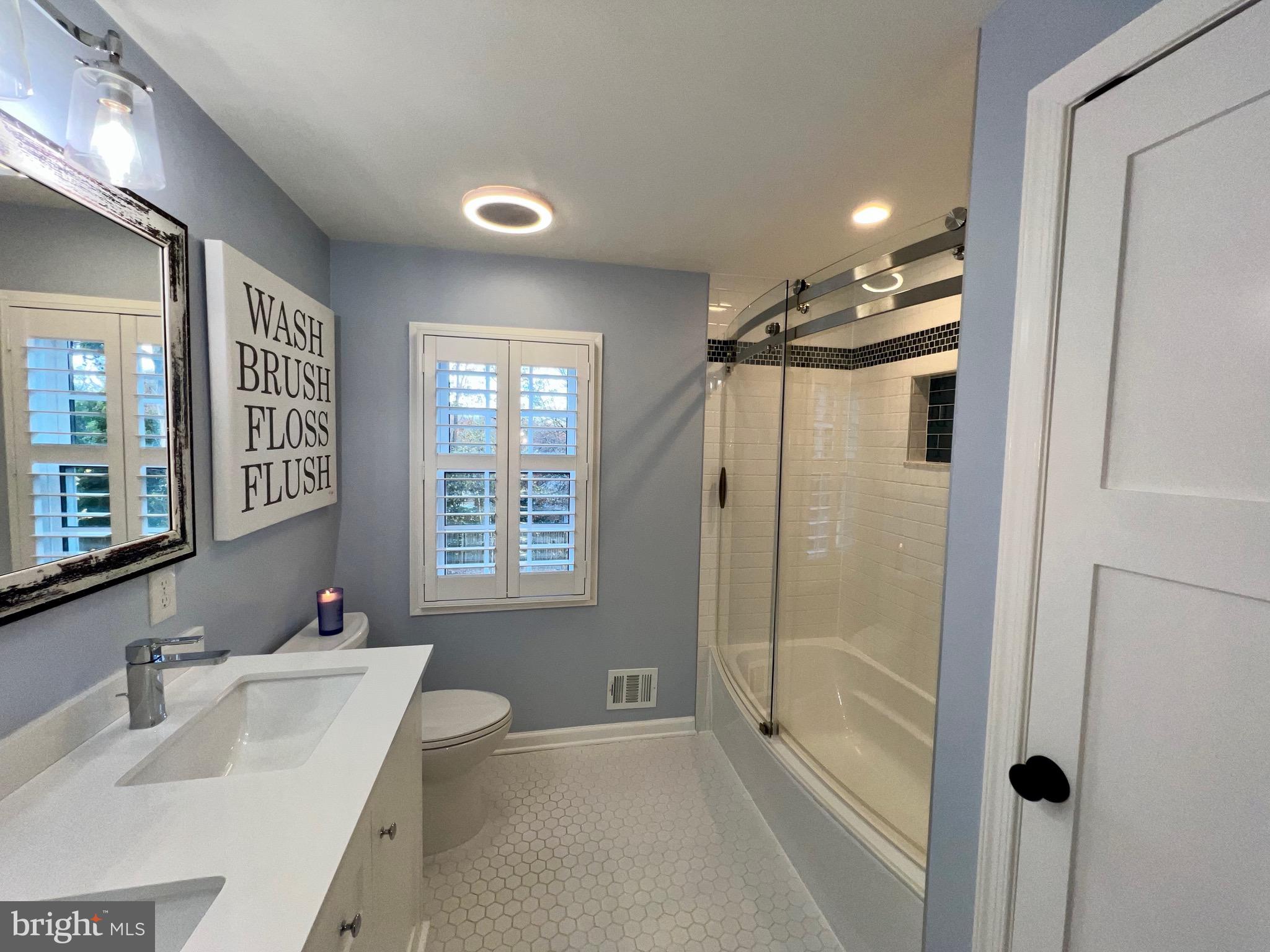 909 St Stephens Road Alexandria, VA 22304 - Photo 26 of 40 a bathroom with a tub sink shower and mirror