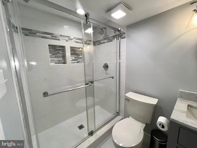 a bedroom with bed and a night stand