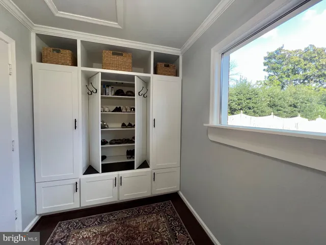 a front view of a house with a garden and trees