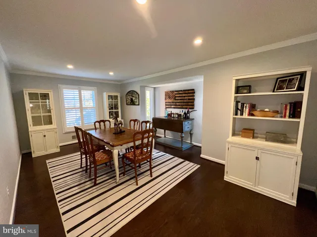 a living room with furniture a wooden floor and next to window