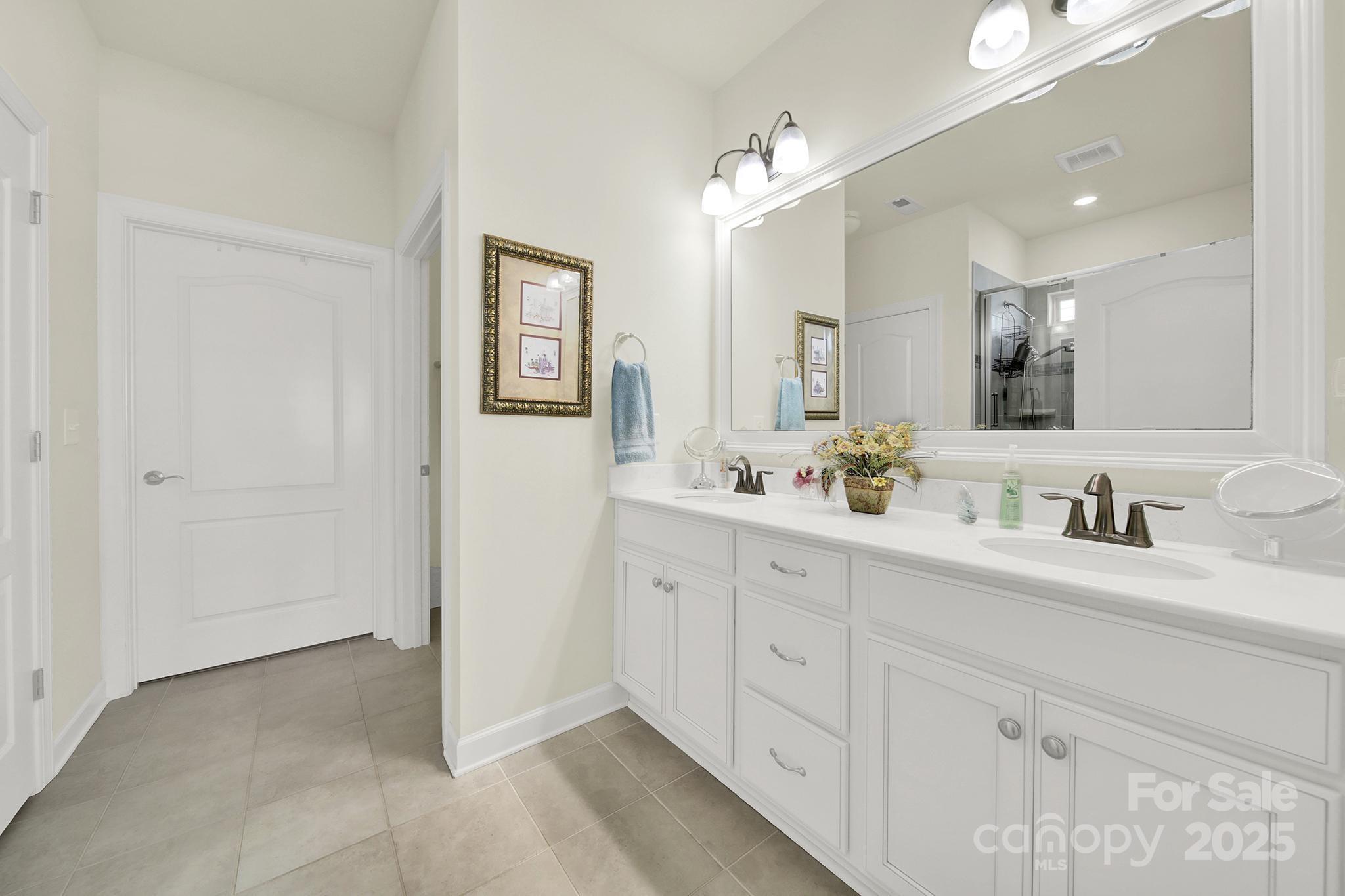 3097 Arches Bluff Circle Lancaster, SC 29720 - Photo 17 of 40 a spacious bathroom with double sink and a mirror