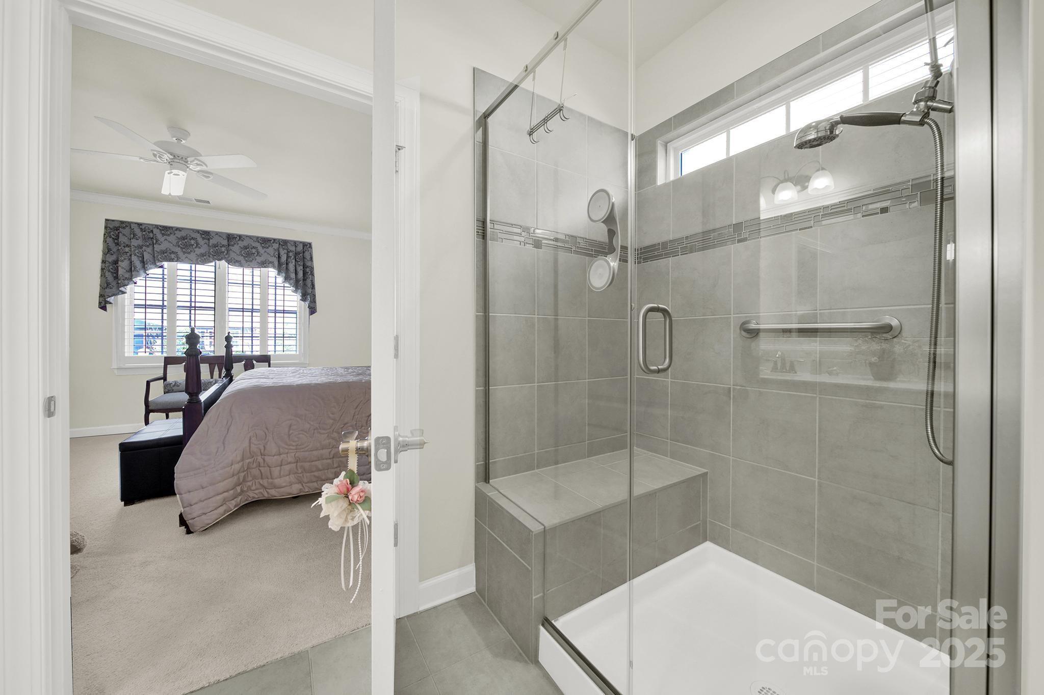 3097 Arches Bluff Circle Lancaster, SC 29720 - Photo 18 of 40 a bathroom with a glass shower door