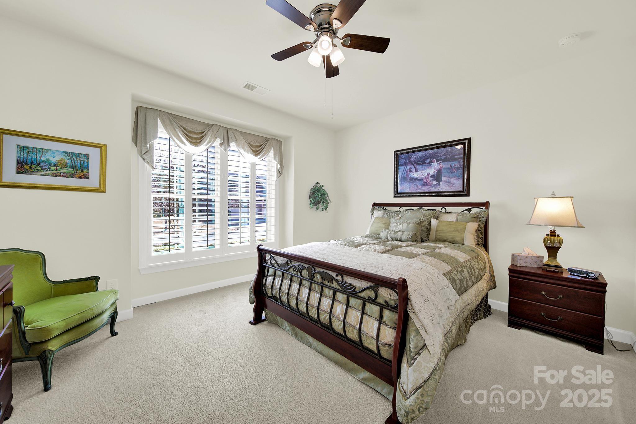 3097 Arches Bluff Circle Lancaster, SC 29720 - Photo 20 of 40 a bedroom with a bed and a chandelier