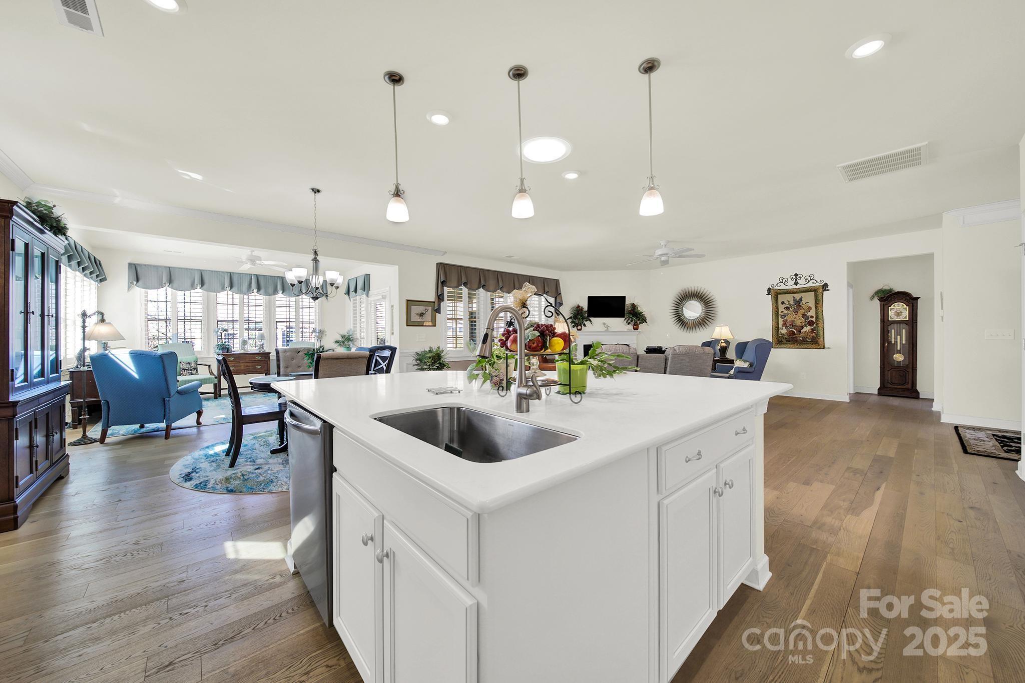 3097 Arches Bluff Circle Lancaster, SC 29720 - Photo 7 of 40 a kitchen with stainless steel appliances granite countertop a sink and a wooden floors