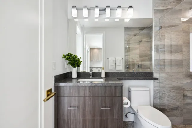 a living room with furniture a chandelier and a painting